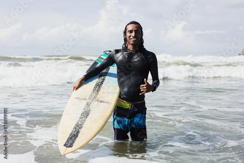 Photography portrait of latin surfer man rides the tropical waves in Mexico Latin America, h