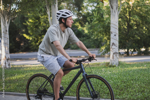 adult man learning and tries how  to ride a bike outdoor on a sunny day photo