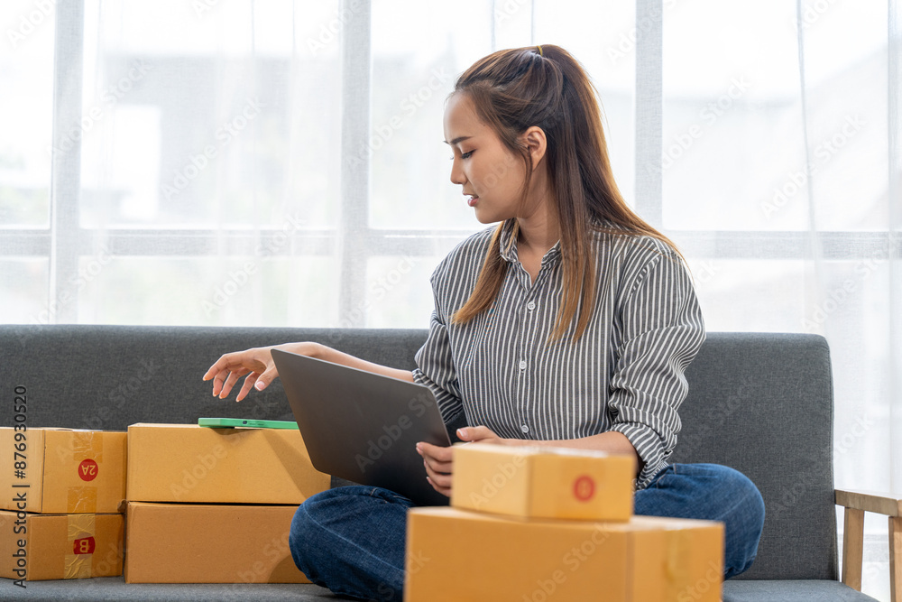asian young woman owner packing product box prepare to the package for delivery to the customer on sofa at home office asian Entrepreneur SME business asian young woman owner packing product box prepare to the package for delivery to the customer on sofa at home office asian Entrepreneur SME business