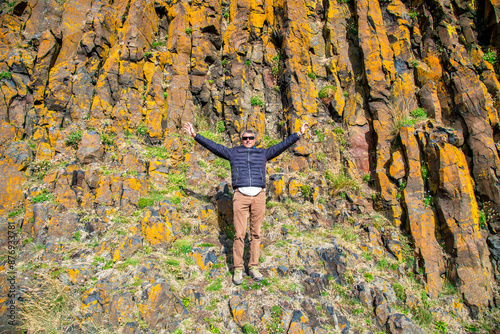 A man with open arms in Stykkisholmur, Iceland photo