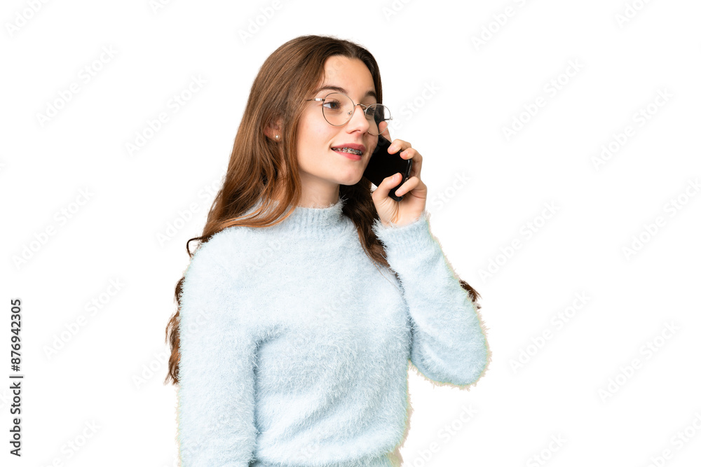Teenager girl over isolated chroma key background keeping a conversation with the mobile phone Teenager girl over isolated chroma key background keeping a conversation with the mobile phone