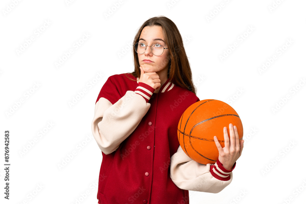 Teenager girl playing basketball over isolated chroma key background having doubts Teenager girl playing basketball over isolated chroma key background having doubts