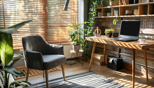 Cozy workplace with modern laptop on desk and comfortable chair at home