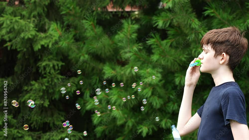 Child blowing soap bubbles in park. Child blowing soap bubbles in park.