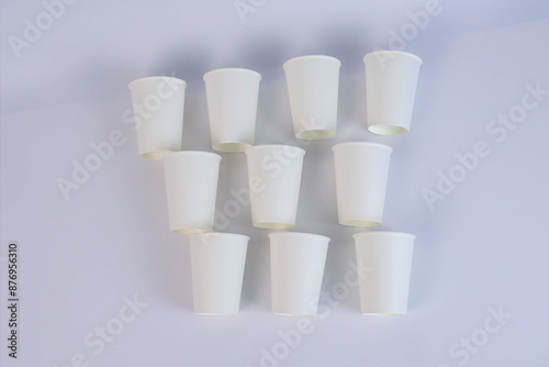  many white glasses lie on a cardboard table. High quality photo