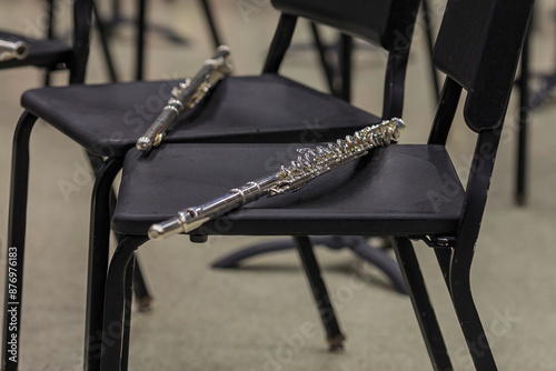 two flutes resting on chairs at a band camp rehearsal