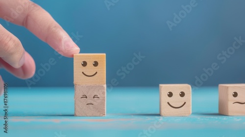 world mental health day concept or feedback rating and positive customer review, Businessman hand choose smile face, wood cube with happiness and sadness face icon on blue background