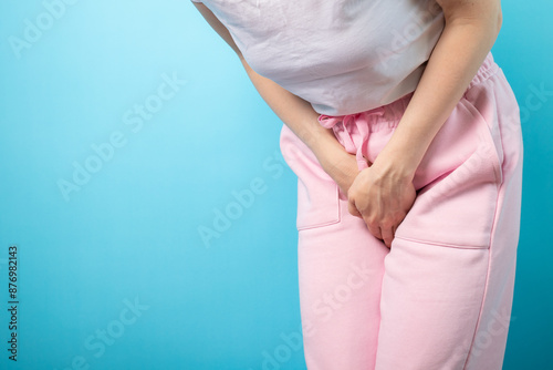 Urinary incontinence, woman holding crotch, urgent need to urinate, health issue, cystitis.