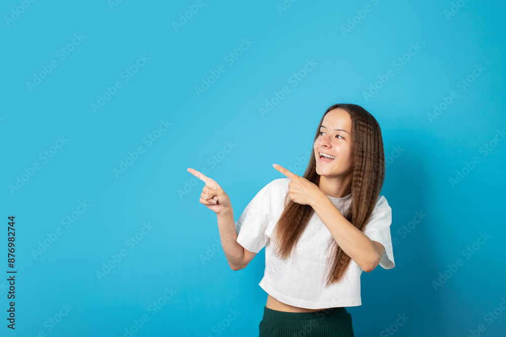 Teenager portrait on green background, young cute emotional student, points to an empty space for text, copy space, curly-haired teen posing, cheerful person with a joyful expression, fun and stylish Teenager portrait on green background, young cute emotional student, points to an empty space for text, copy space, curly-haired teen posing, cheerful person with a joyful expression, fun and stylish