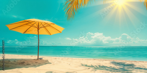 A bright and cheerful beach scene featuring a vibrant yellow umbrella set against clear blue skies, inviting a relaxing day by the seaside with golden sand and sunlight.