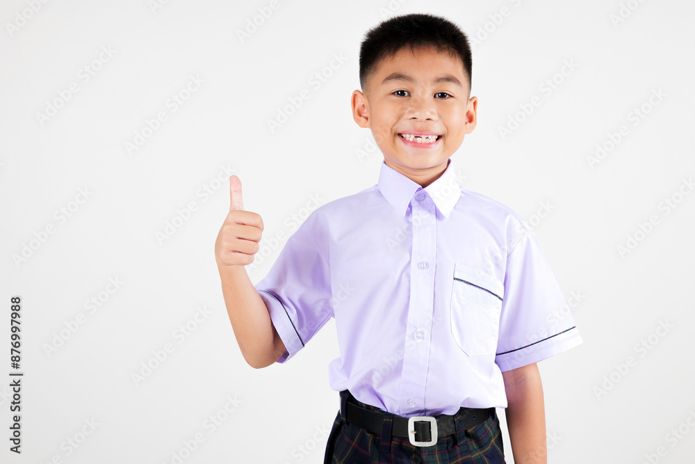 Portrait smile Asian little boy primary posing giving a thumbs up studio isolated white background, happy cute man kid wear school uniform plaid is expressing his approval, back to school concept Portrait smile Asian little boy primary posing giving a thumbs up studio isolated white background, happy cute man kid wear school uniform plaid is expressing his approval, back to school concept