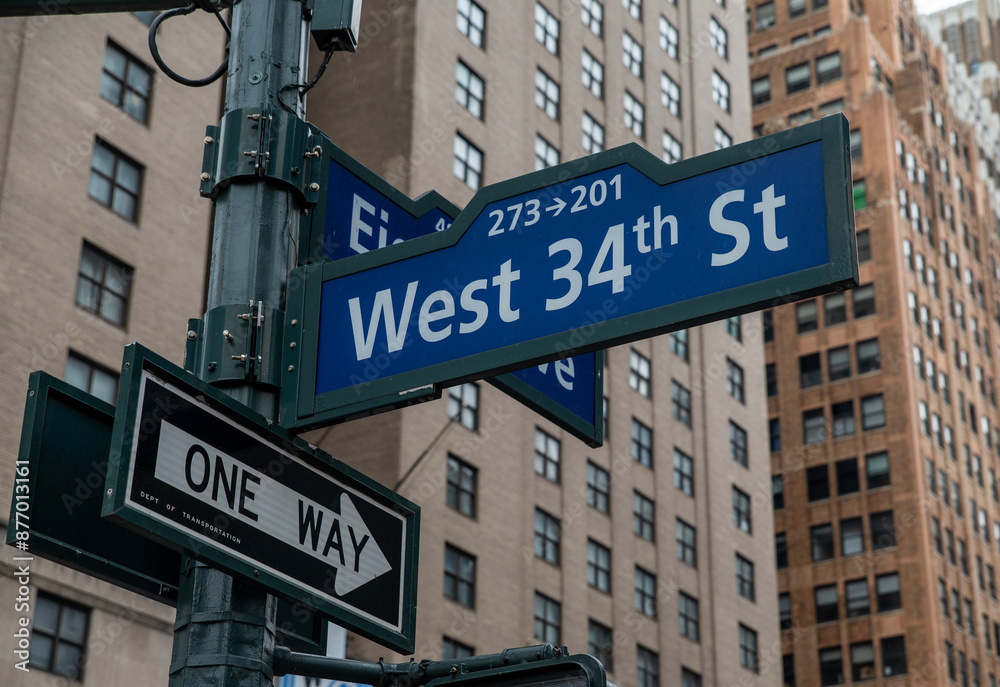 West 34th St sign along city streets, NYC United States tourist attractions West 34th St sign along city streets, NYC United States tourist attractions