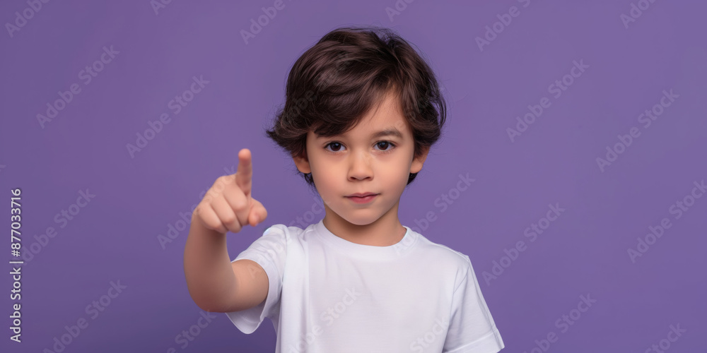 A cheerful schoolboy pointing upwards with a confident expression and a friendly smile. A cheerful schoolboy pointing upwards with a confident expression and a friendly smile.