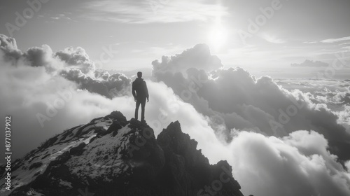 A person stands at the top of a mountain, enjoying the view and taking in the scenery