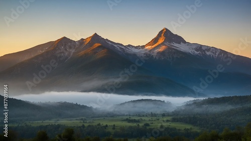 a misty mountain in the early morning with the first