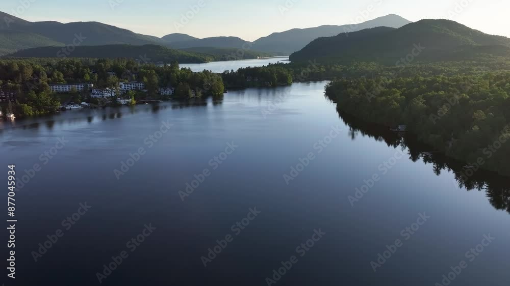 Aerial approaching view of Mirror Lake with Lake Placid in the background Aerial approaching view of Mirror Lake with Lake Placid in the background