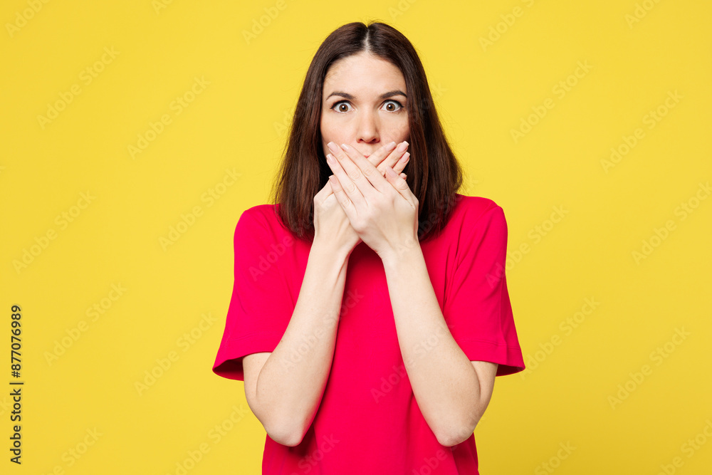 Young shocked surprised astonished scared sad woman wears pink t-shirt casual clothes cover mouth with hand look camera isolated on plain yellow orange background studio portrait. Lifestyle concept