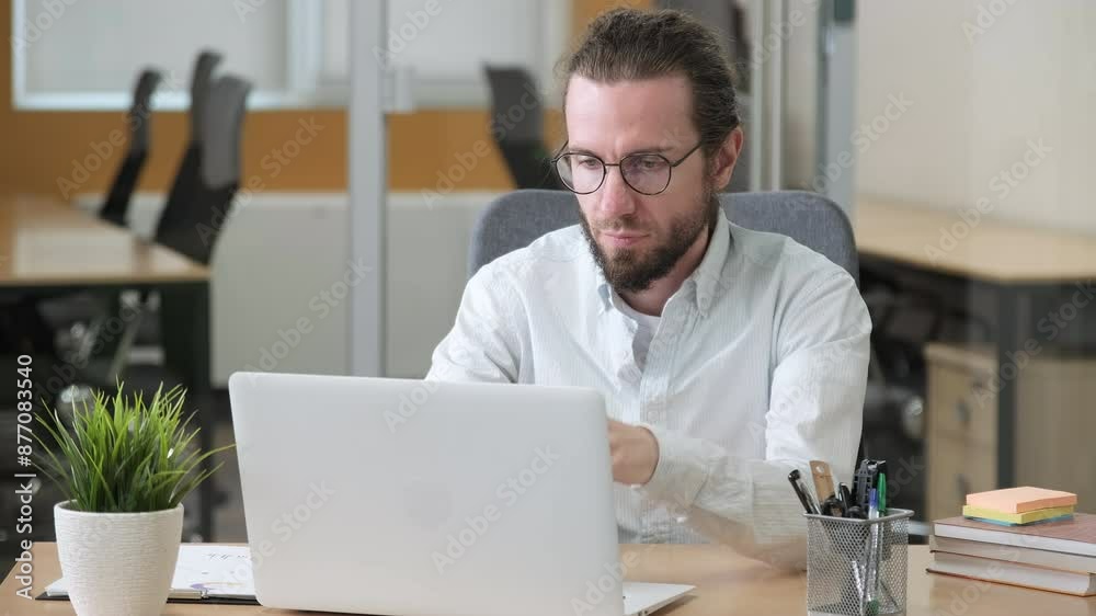 Working man looks problematic and frustrated reactions white working on his laptop. Businessman looks stress while working on his laptop. Working man looks problematic and frustrated reactions white working on his laptop. Businessman looks stress while working on his laptop.