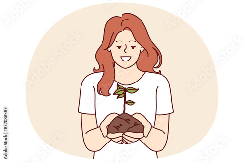 Woman holds handful of earth with plant drawing attention to problem of ecology and pollution or CO2 emissions. Happy girl doing plant cultivation and care for environment or ecology as volunteer