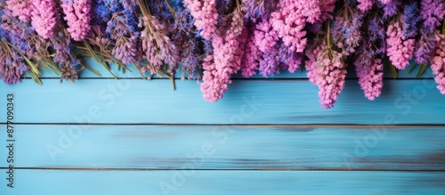 Background of pink and purple lavender flowers on blue wood table with copy space image. photo