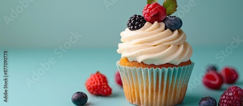 Decorated cupcake with berry garnish on top, perfect for an ad with copy space image. photo