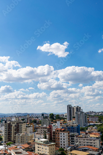 Beautiful blue sky with clouds. Residential buildings. Space for advertising. Vertical.