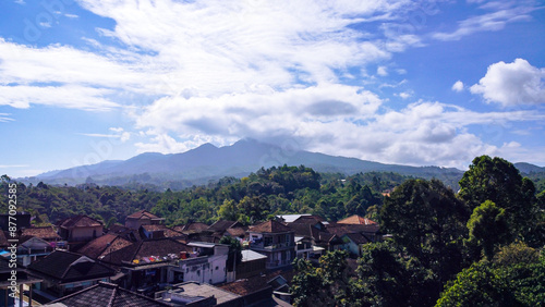 A breathtaking drone shot of Mount Cikuray in Garut Regency, West Java, the fourth highest peak in the region, revealing its majestic slopes and lush greenery from a bird's-eye perspective.