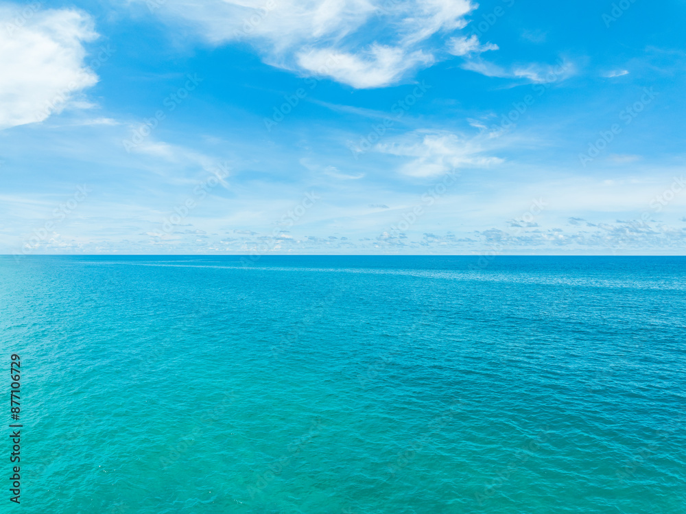 Fototapeta premium Aerial view of Blue sea and sky clouds background,Summer Nature tropical sea, Beautiful ocean water travel background
