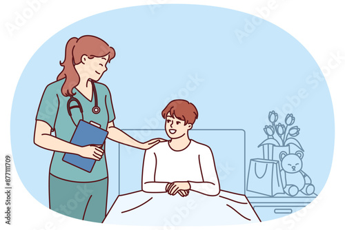 Woman doctor near boy lying on bed in hospital after complications of chronic disease. Doctor pediatrician supports teenager undergoing rehabilitation in hospital after complex operation