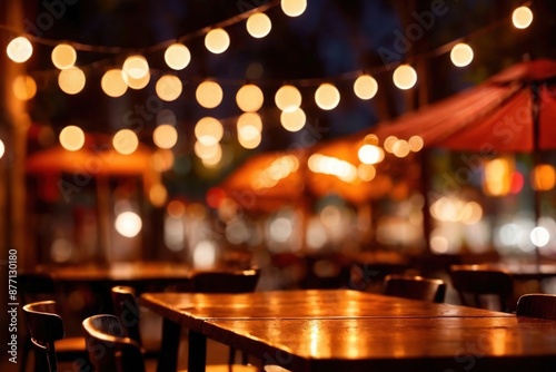 Wooden tabletop countertop backdrop with blurred background of outdoor restaurant at night with festive bokeh lights