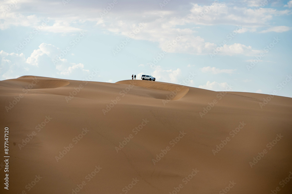 car on the sand dunes in the desert car on the sand dunes in the desert