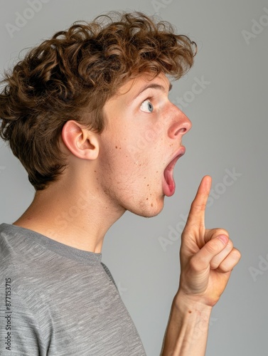 A young person posing with a silly expression and hand gesture photo