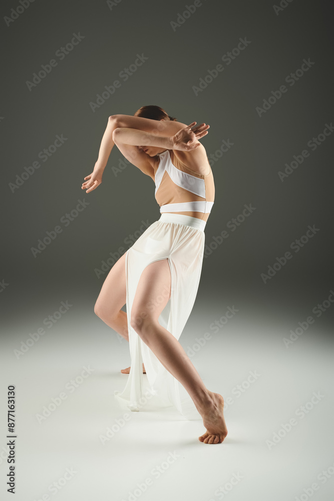 A young, beautiful ballerina in a white dress dances gracefully. A young, beautiful ballerina in a white dress dances gracefully.