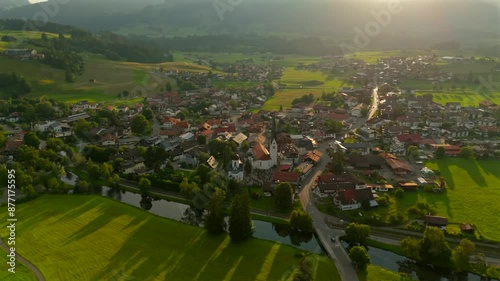 Aerial view of Fischen im Allgau near Oberstdorf at sunset in sunny summer weather in Bavaria, Germany Landkreis Oberallgau. Fischen im Allgaeu Luftaufnahme. Pfarrkirche St. Verena. Frauenkapelle.  photo