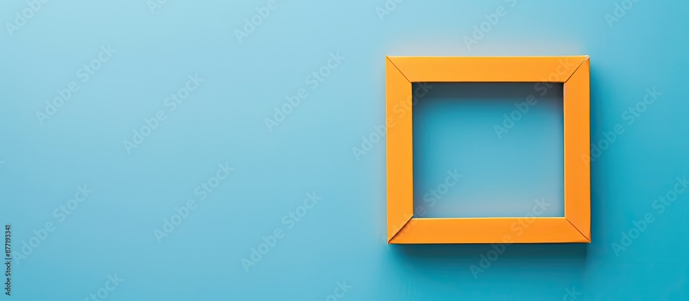 Minimal concept trendy greeting card with an empty orange frame on a classic blue background providing copy space image in flat lay style from a top view Minimal concept trendy greeting card with an empty orange frame on a classic blue background providing copy space image in flat lay style from a top view