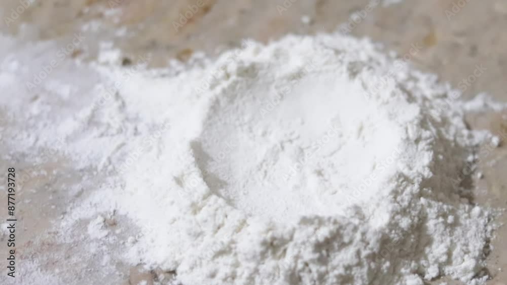dough falling in slow motion on fine wheat or flour powder dough falling in slow motion on fine wheat or flour powder