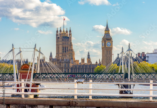 Big Ben and Houses of Parliament seen from Waterloo bridge through Golden Jubilee bridge, London, UK photo