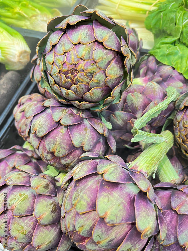 Obraz premium Title: Fresh Organic Purple Artichokes in Market Display