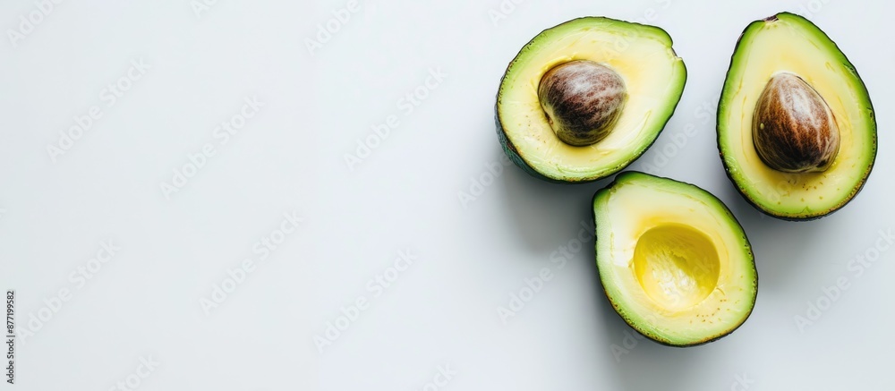 Avocado halved showing its freshness on a clean white backdrop with copy space image Avocado halved showing its freshness on a clean white backdrop with copy space image
