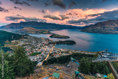 Beautiful sunset sky over illuminated Queenstown with Lake Wakatipu at New Zealand