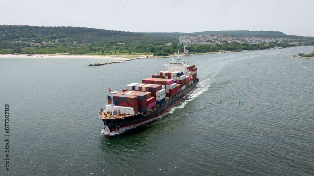 Large container ship leaving port. Aerial view of cargo container ship vessel import export container sailing. Large container ship leaving port. Aerial view of cargo container ship vessel import export container sailing.