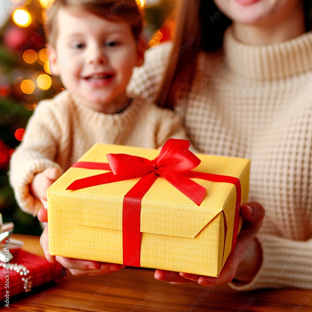 Smiling Child and Mother Exchanging Christmas Gifts by a Decorated Tree at Home Smiling Child and Mother Exchanging Christmas Gifts by a Decorated Tree at Home
