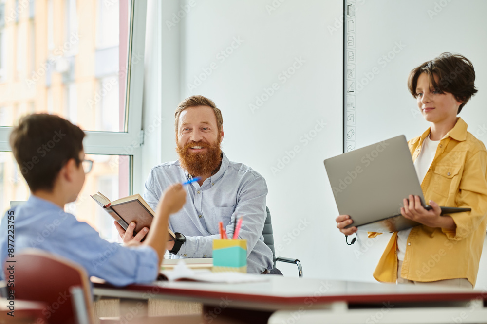 A group of individuals, including a teacher, engaged in a collaborative learning session around a table with laptops in a bright and lively classroom setting. A group of individuals, including a teacher, engaged in a collaborative learning session around a table with laptops in a bright and lively classroom setting.