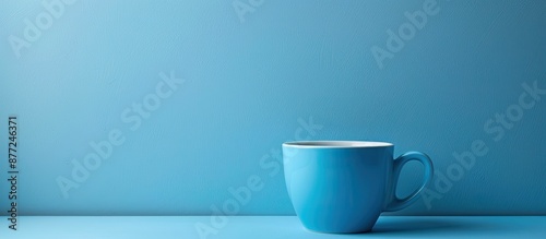 Blue cup on a blue backgrou...