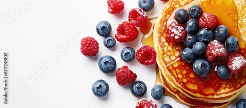 Delicious American pancakes topped with raspberries blueberries and honey perfect for a family breakfast scene with a copy space image photo