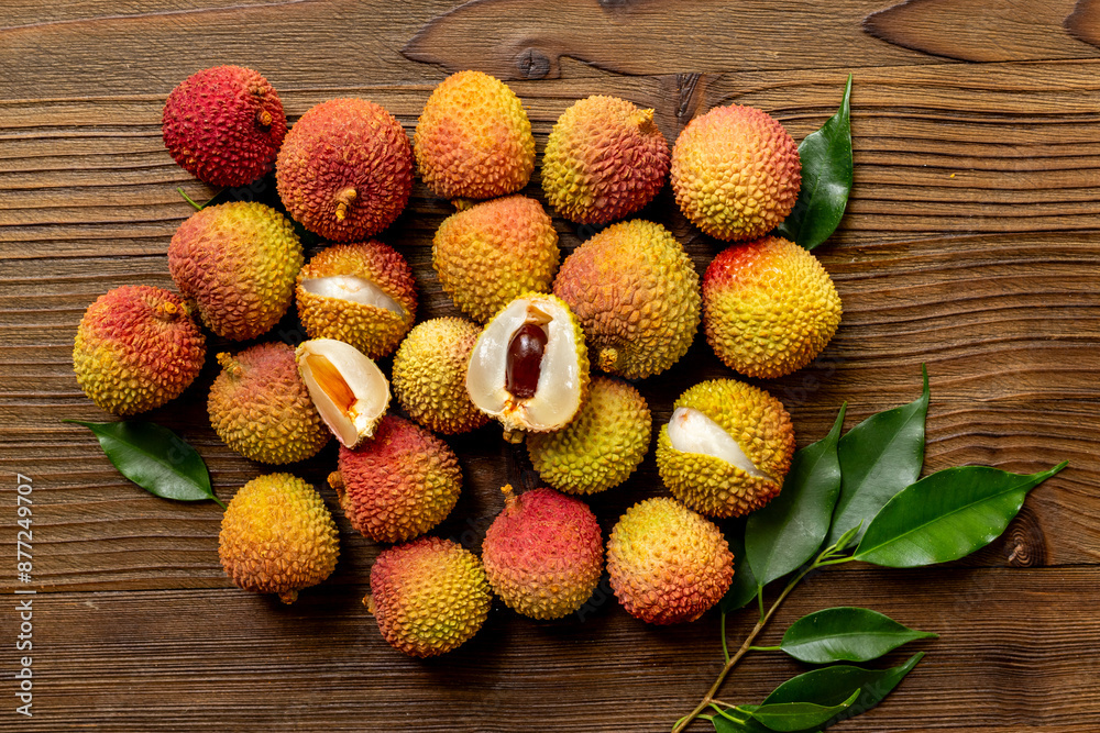 Juicy fresh lychee tropical fruit with cut in half and green leaves. Tropical fruit background Juicy fresh lychee tropical fruit with cut in half and green leaves. Tropical fruit background