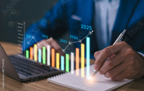 Obraz na płótnie 2025 business financial plan market concept, performance of profit growth on 2024 to 2025 education trend up finance on growth graph money revenue, Businessman analyzes profitability of working. w salonie