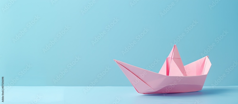 Pink paper boat handmade set on a light blue backdrop with copy space image Pink paper boat handmade set on a light blue backdrop with copy space image