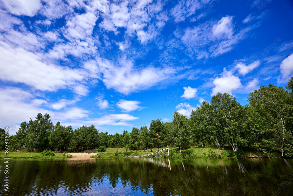 Beautiful summer river at sunny day with clouds reflection in the water Beautiful summer river at sunny day with clouds reflection in the water