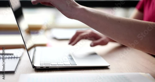 Wallpaper Mural Female manager opens modern laptop to continue typing report. Woman ready to work on electronic device sitting at table in office slow motion Torontodigital.ca